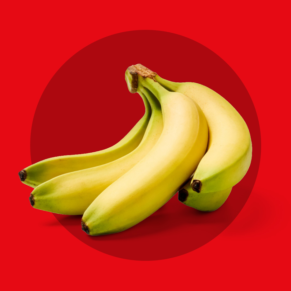 Grozd žutih banana na crvenoj pozadini sa kružnim preklapanjem.